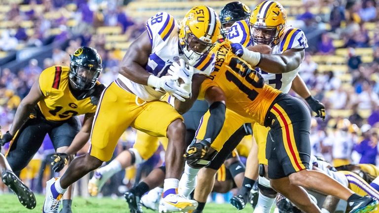 LSU's Kaleb Jackson (28) runs the ball against Grambling State...