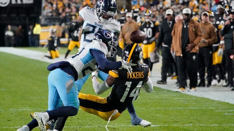 Pittsburgh Steelers wide receiver George Pickens (14) fumbles the ball...