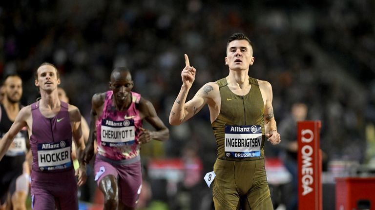 Jakob Ingebrigtsen, of Norway, crosses the finish line to win...