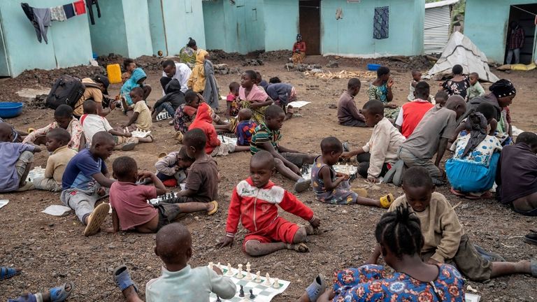 Children play a chess at 'The Soga Chess Club' of...