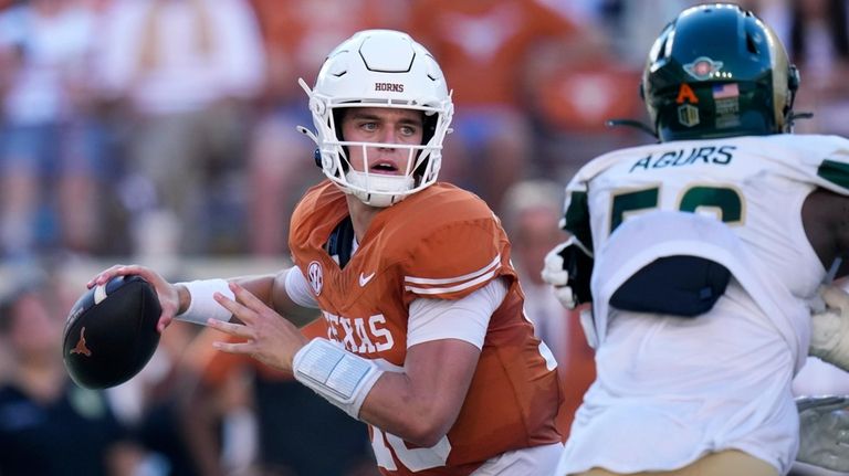 Texas quarterback Arch Manning, left, throws against Colorado State during...