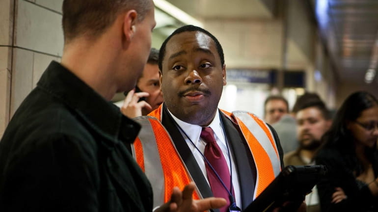 Justin Peterson, LIRR's first customer service ambassador, uses a tablet...