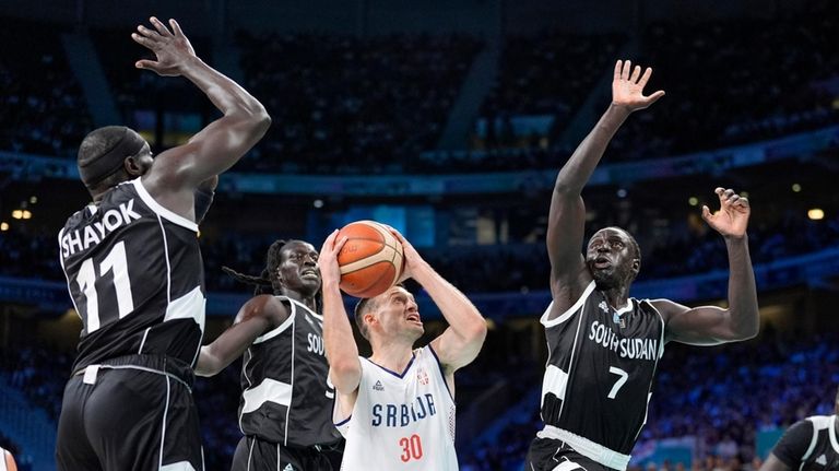 Serbia's Aleksa Avramovic, second from right, shoots as South Sudan's...