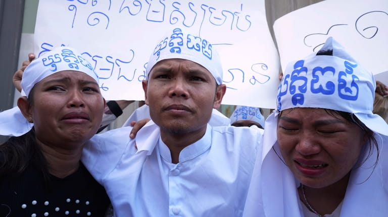 An environmental activist, center, with his supporters, gather near Phnom...