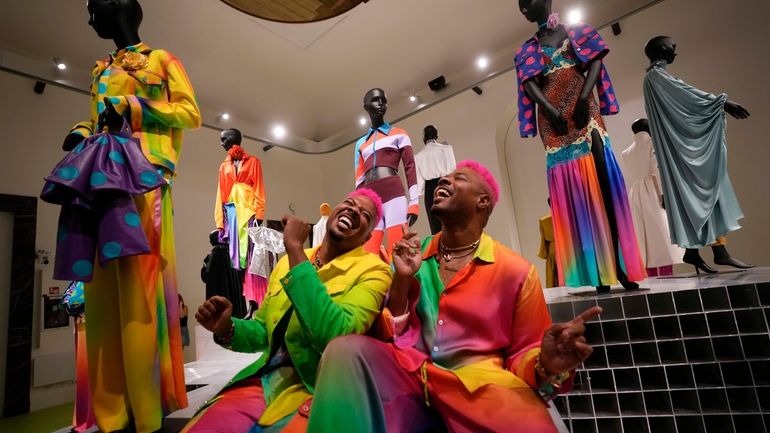 From left, designers Glen and Bruce Proctor laugh as they...