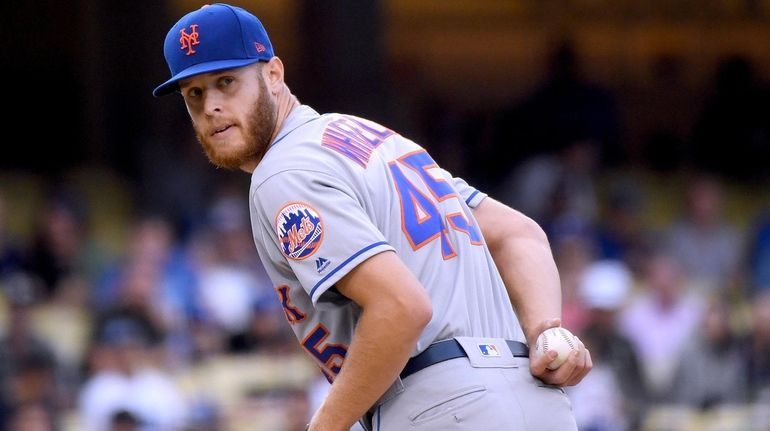 Zack Wheeler #45 of the New York Mets looks back...