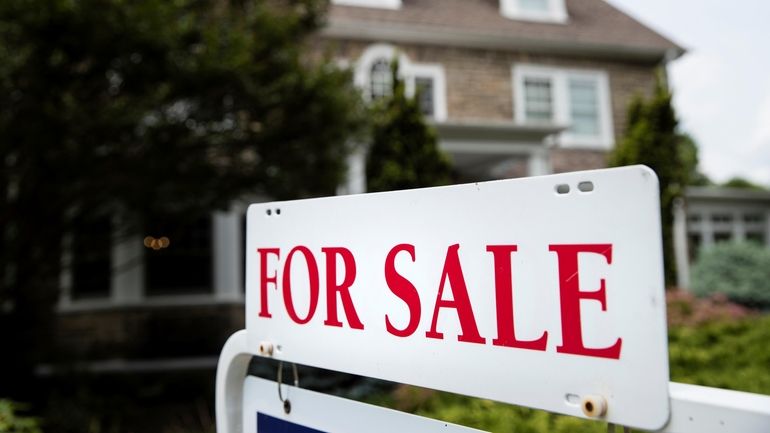 A "for sale" sign stands in front of a house in Jenkintown,...