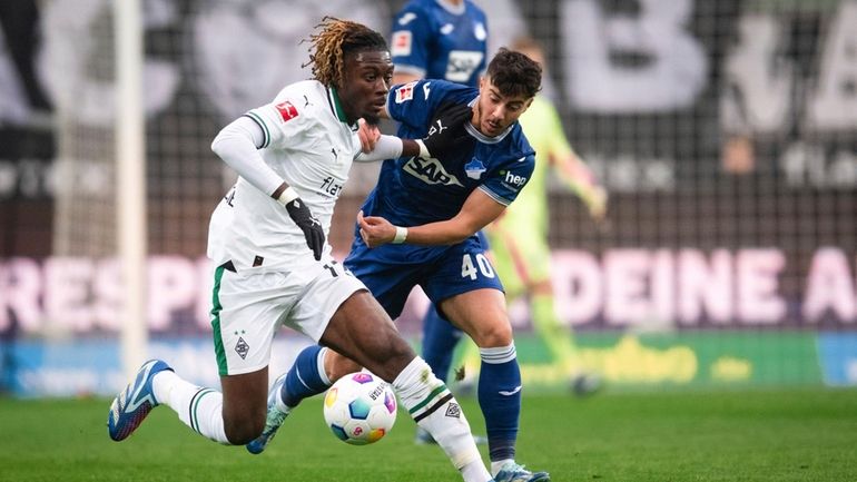 Gladbach's Manu Kone, left, and Hoffenheim's Umut Tohumcu fight for...