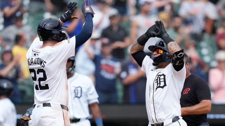 Detroit Tigers' Javier Báez, right, is greeted by Parker Meadows...