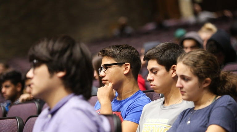 Students look on during a debate between William Lindsay III...