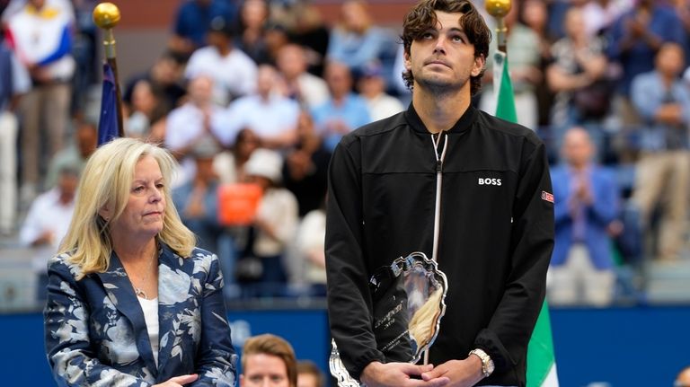 Taylor Fritz, of the United States, holds the finalist trophy...