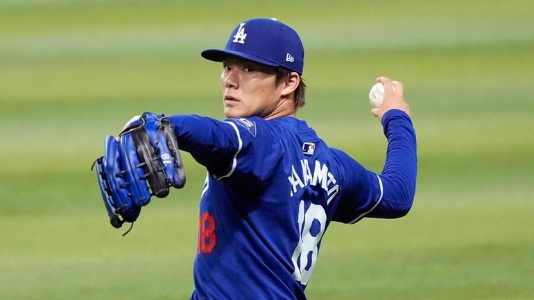 Injured Los Angeles Dodgers starting pitcher Yoshinobu Yamamoto, of Japan,...