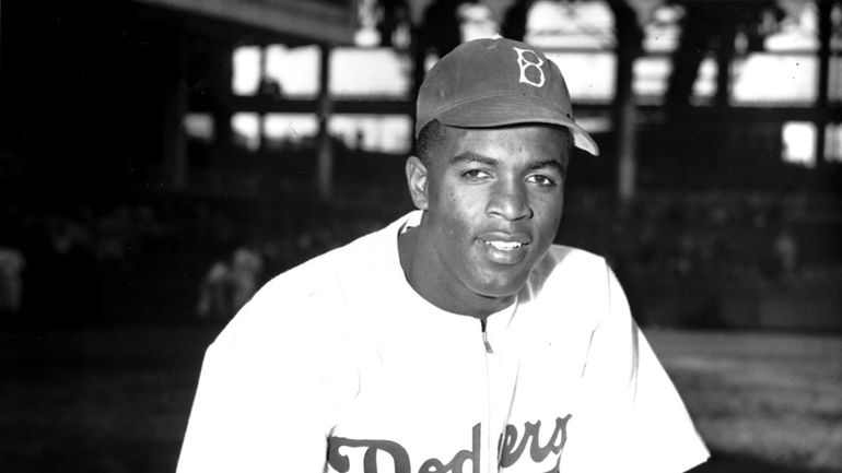 Jackie Robinson of the Brooklyn Dodgers poses at Ebbets Field...