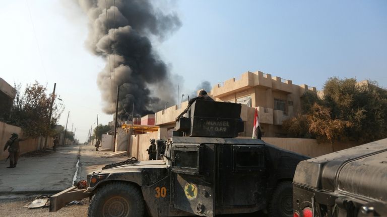 Smoke rises as Iraq's elite counterterrorism forces fight against Islamic...