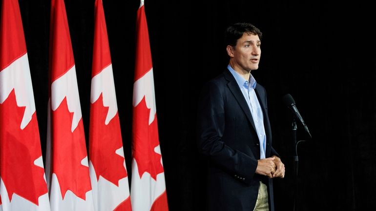 Canadian Prime Minister Justin Trudeau speaks with reporters during a...