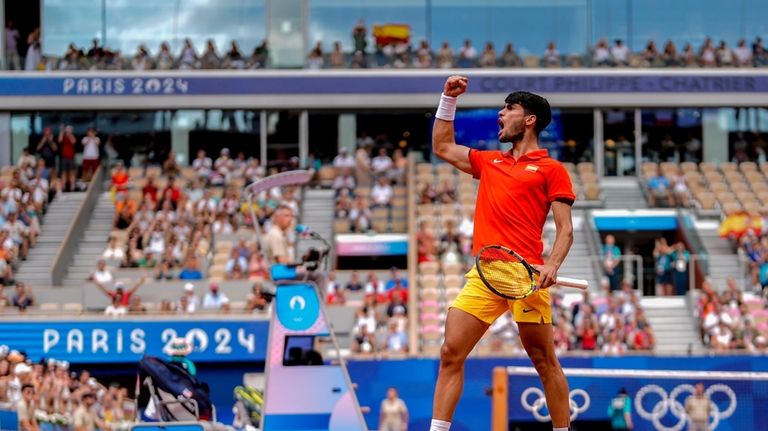 Carlos Alcaraz of Spain celebrates a point against Tommy Paul,...