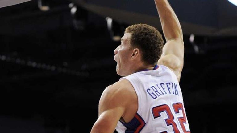 Blake Griffin hands on his waist in a Clippers red jersey