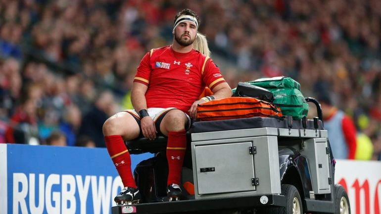 Wales' Scott Baldwin is taken off the pitch during the...