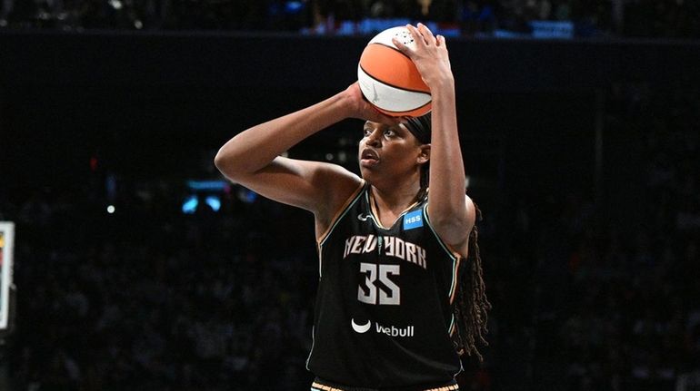 Liberty forward Jonquel Jones shoots over Las Vegas Aces forward...