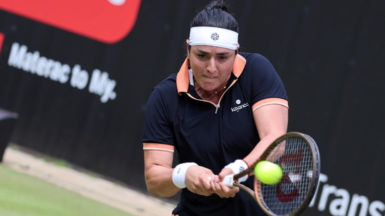 Tunisia's Ons Jabeur returns a ball against Coco Gauff of...