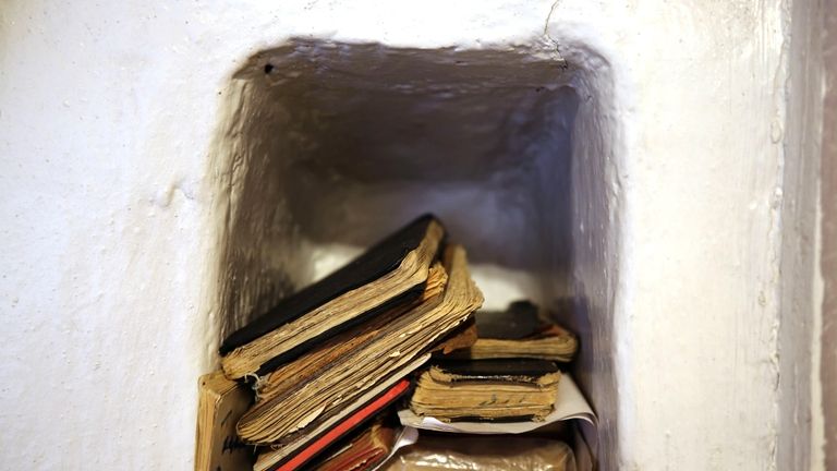 Handbooks of prayers and hymns, known as 'cuadernos', sit in...