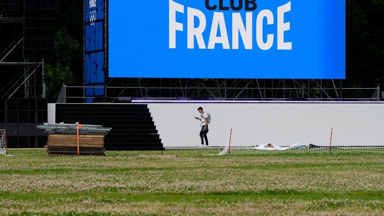 A person walks near a stage at France's house at...