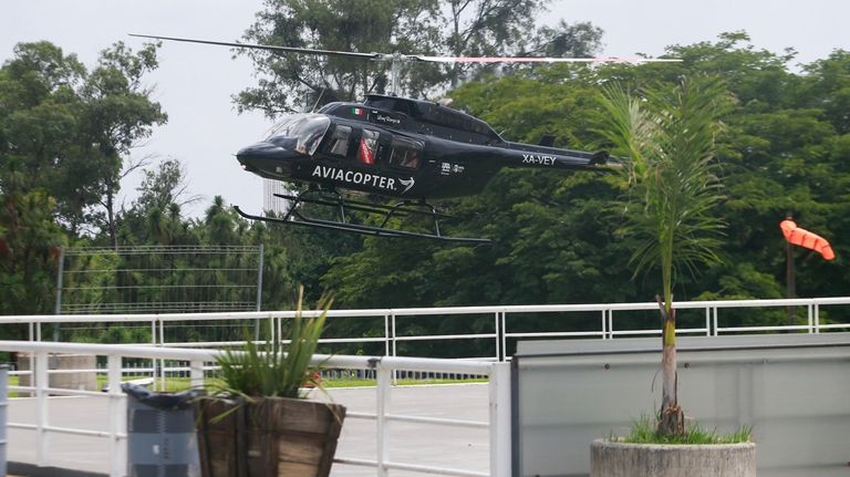 A helicopter transports Poland's Katarzyna Piter and Hungary's Fanny Stollar...