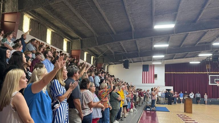 Students, teachers and community members pack the Morgan Academy gym...