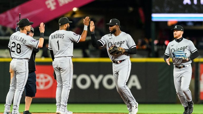 The Chicago White Sox players, from left to right, Zach...