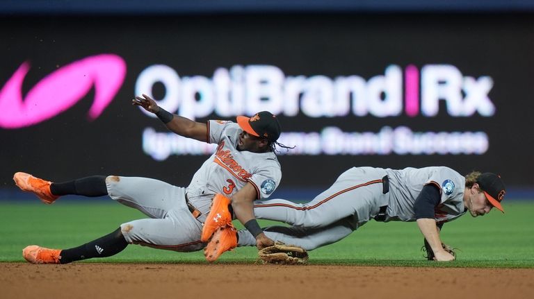 Baltimore Orioles second baseman Jorge Mateo, left, and shortstop Gunnar...