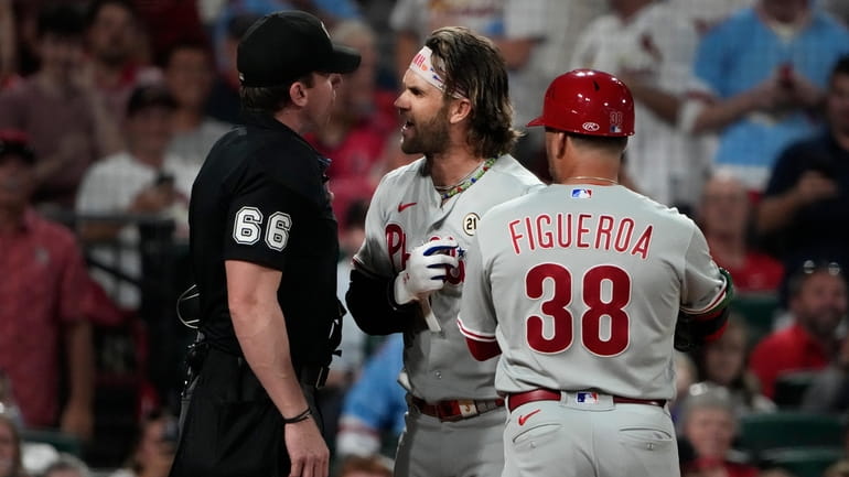 Philadelphia Phillies' Bryce Harper argues with home plate umpire Alex...