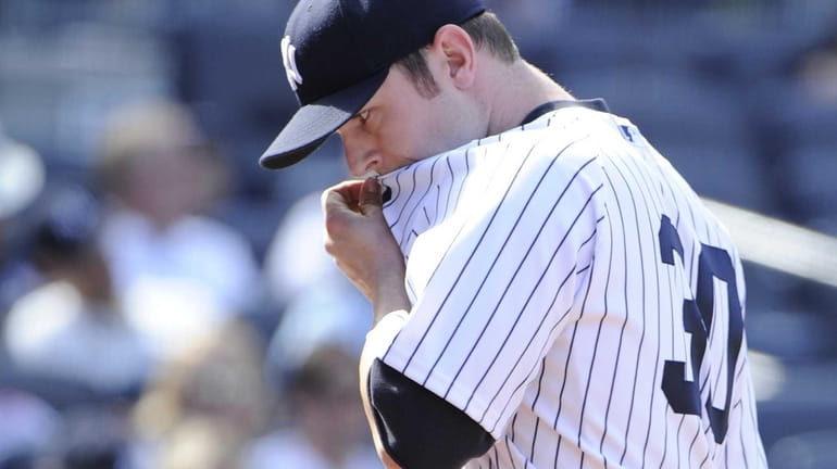 Yankees pitcher David Robertson reacts as he walks to the...