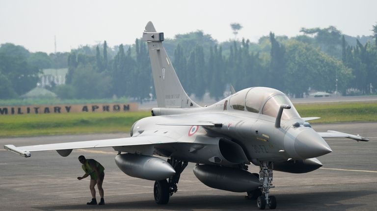 A crew member inspects a France's Rafale fighter jets during...