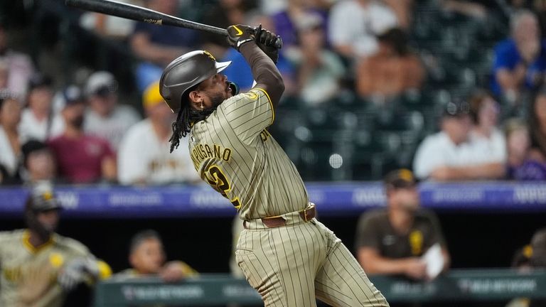 San Diego Padres' Luis Campusano follows the flight of his...