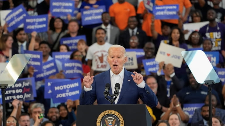 President Joe Biden gestures while speaking to supporters at a...