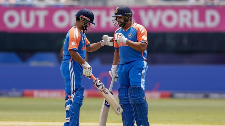 India's Rishabh Pant, left, is congratulated by his captain Rohit...