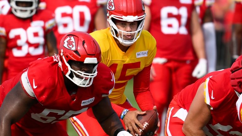 Kansas City Chiefs quarterback Patrick Mahomes takes a snap during...