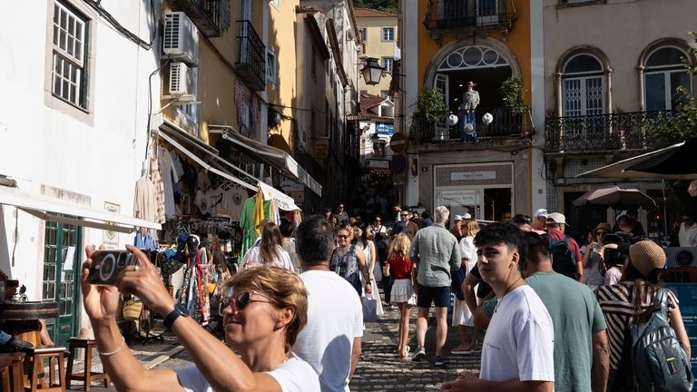 Tourists visit the old center of Sintra, Portugal, Friday, Aug....