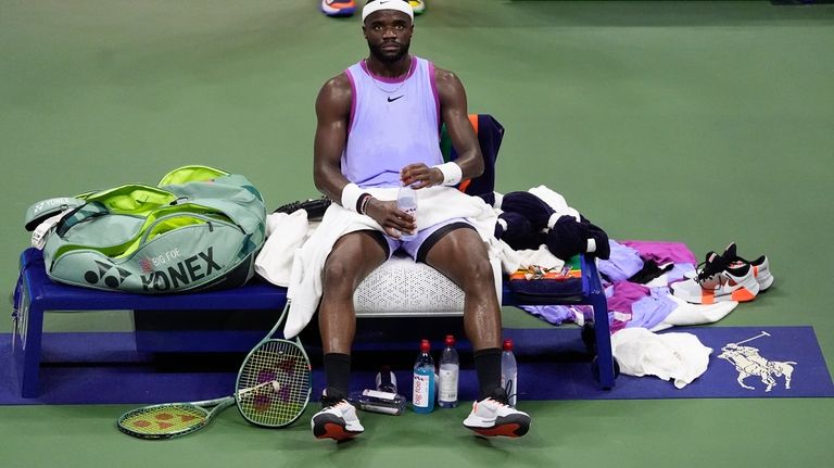 Frances Tiafoe, of the United States, takes a break between...