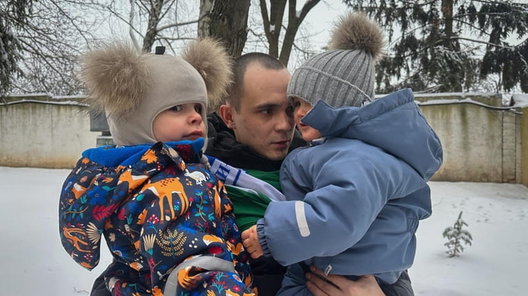 After a prisoner exchange, Artem Dmytryk hugs his 2-year-old son,...