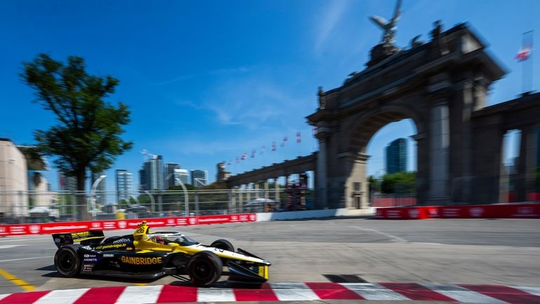 Colton Herta zooms around the track on his way to...