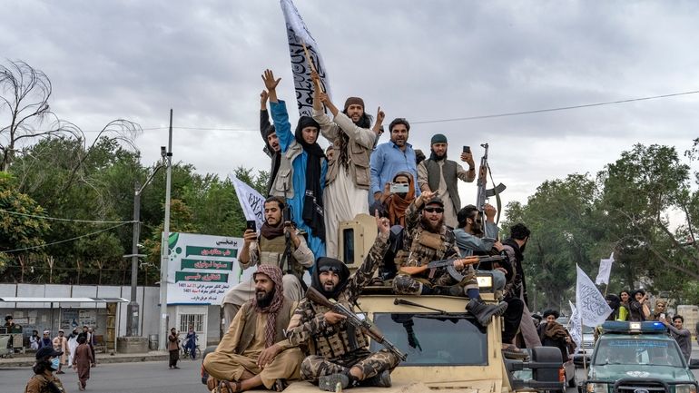 Taliban fighters celebrate one year since they seized the Afghan...