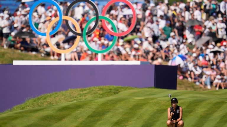 Lydia Ko, of New Zealand, looks at her putt on...