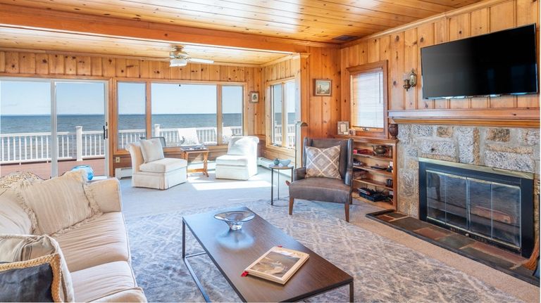 This Northport home boasts wooden paneling and a fireplace.