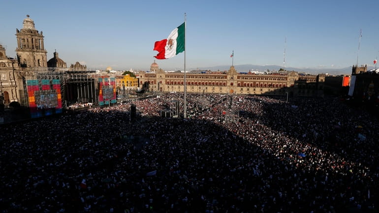 People gather in the Zocalo to celebrate Mexico's newly sworn-in...