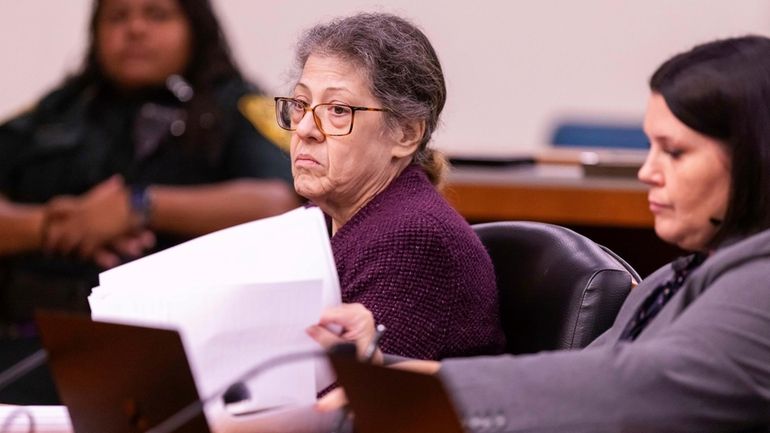 Susan Lorincz, left, and her attorney listen to testimony during Lorincz's...