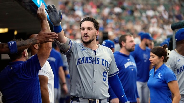 Kansas City Royals' Vinnie Pasquantino (9) is greeted in the...