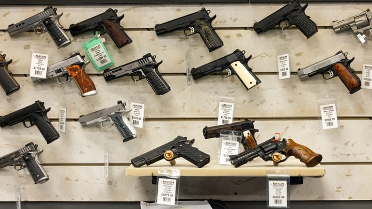 Guns for sale are displayed at Maxon Shooter's Supplies in...