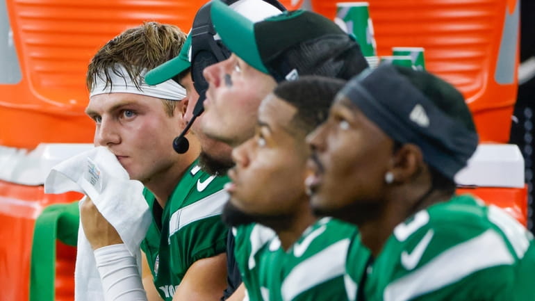 Jets quarterback Zach Wilson sits on the bench during the...