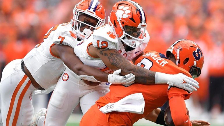 Clemson defensive ends Justin Mascoll, left, and T.J. Parker sack...